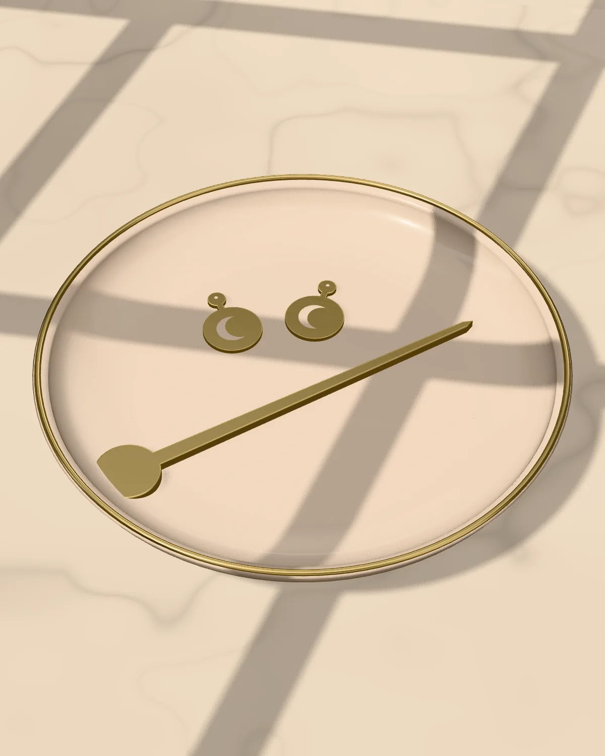 A brass hair stick and crescent earrings resting in a glazed trinket dish