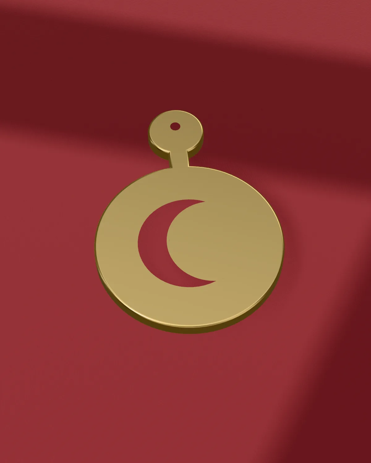 Brass crescent earring laid on velvet, close
