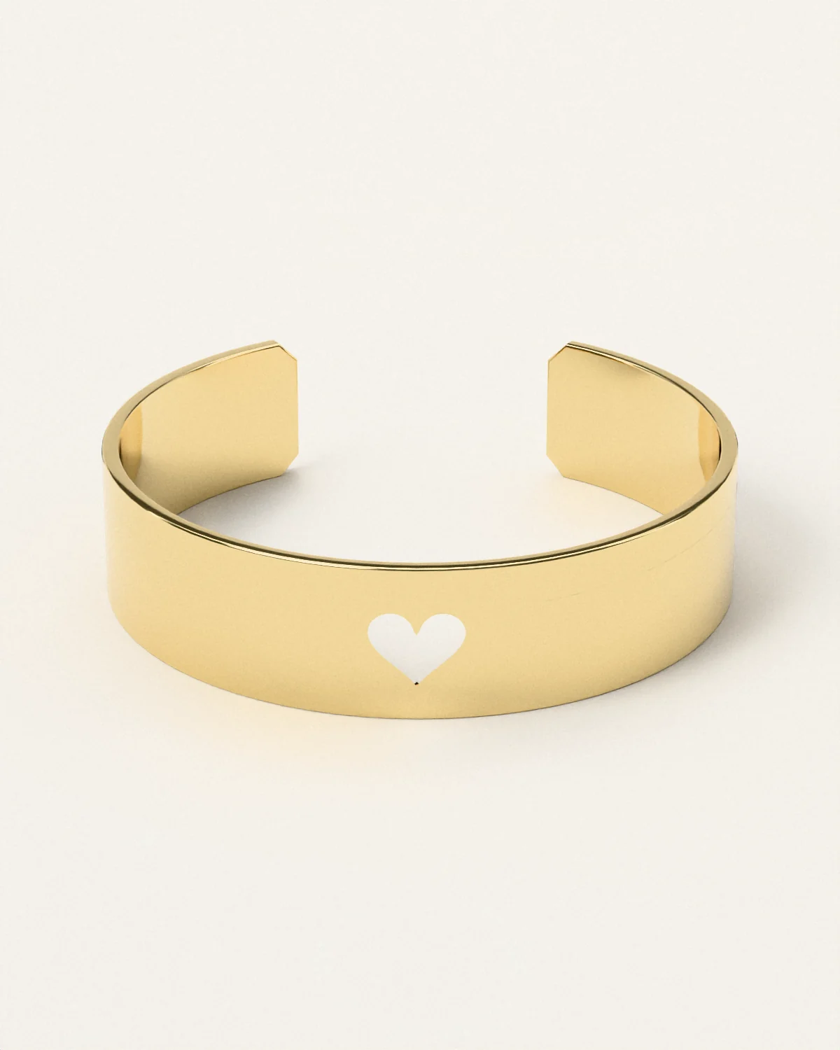 Brass heart cuff, laid on its side, the heart toward you