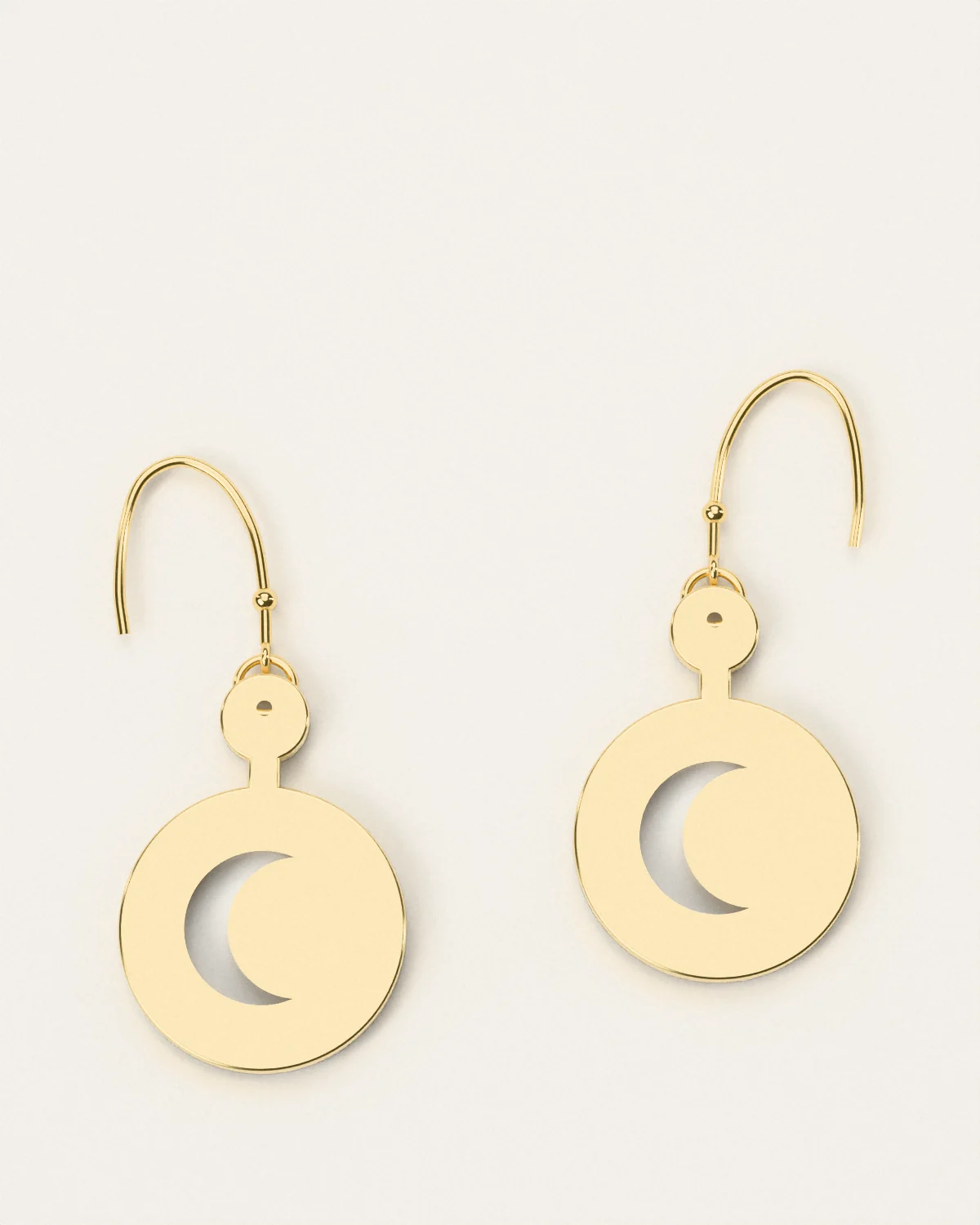 Brass crescent earrings, a pair laid flat