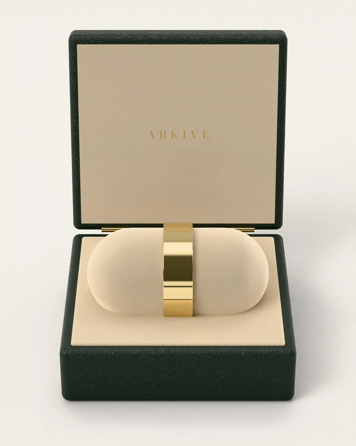 A brass cuff on a suede cushion in the open Arkive case