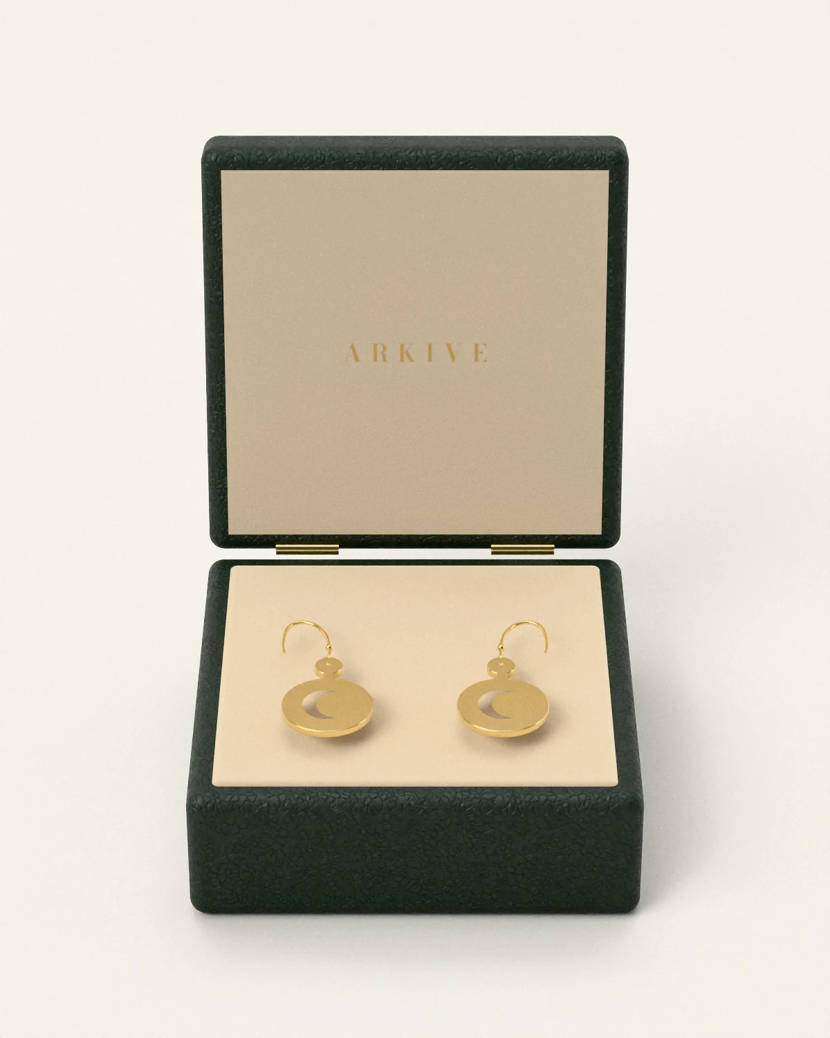 Brass crescent earrings in the Arkive case